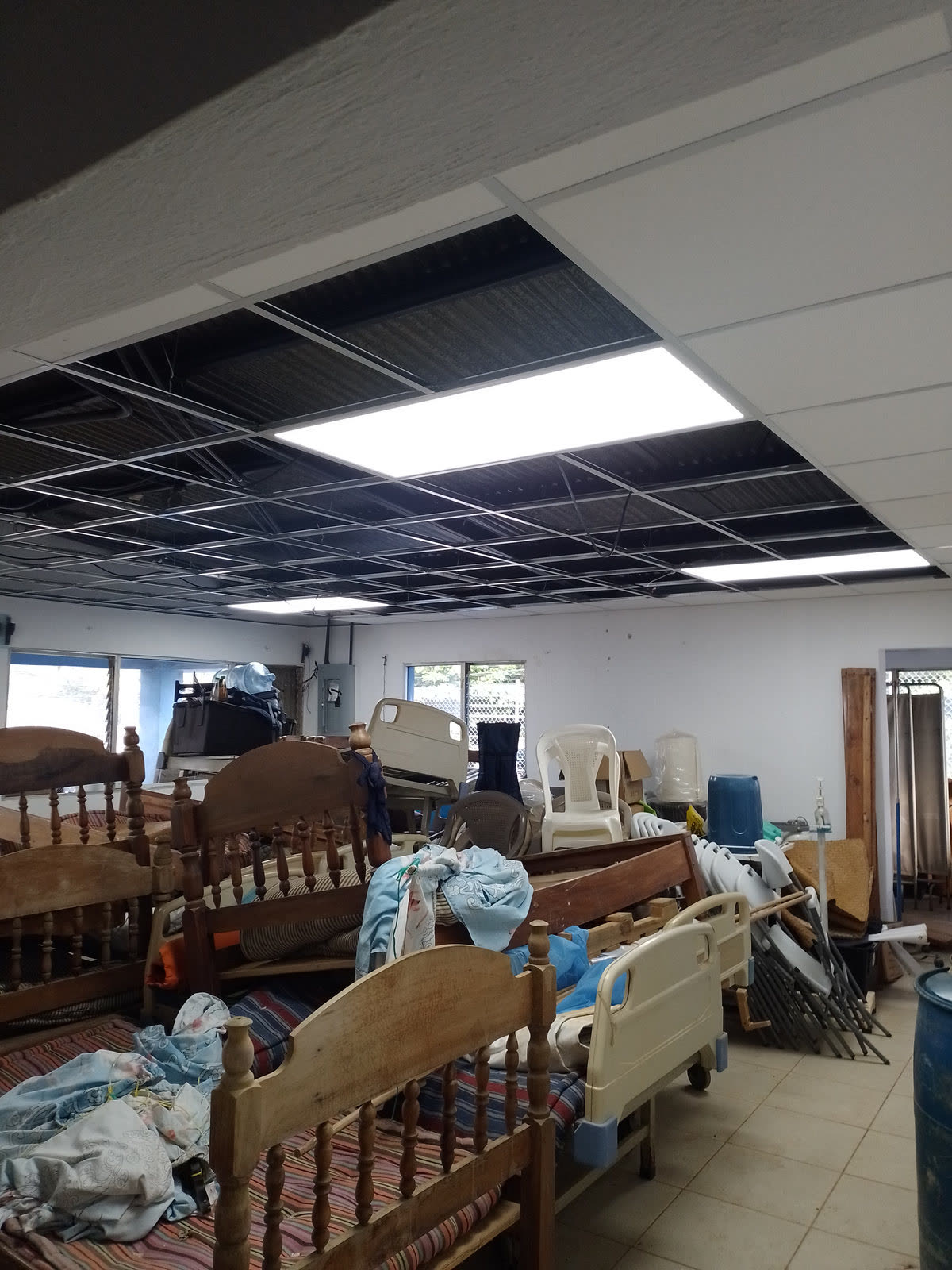 Hospital beds and supplies stored in an unused room