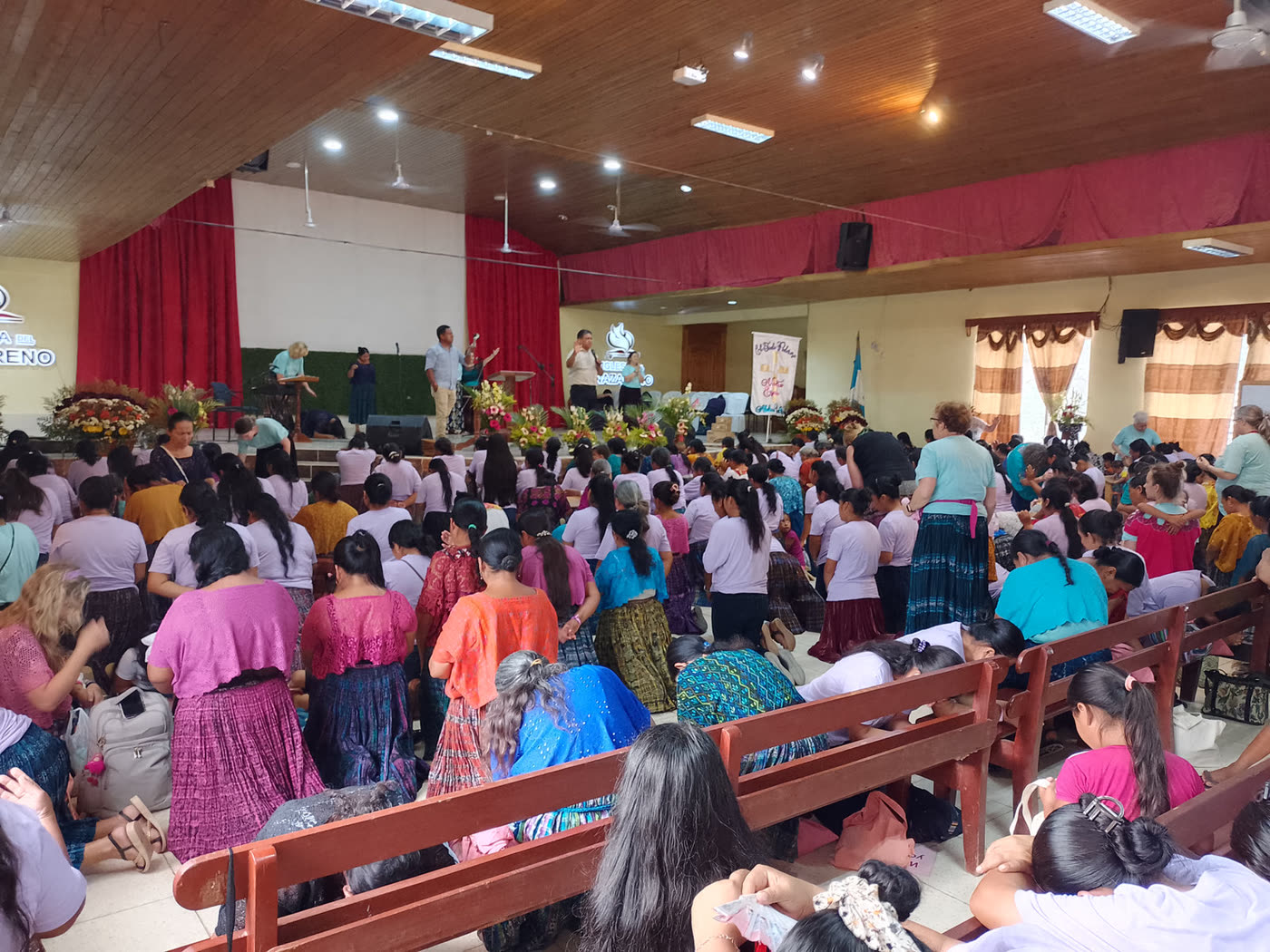 A large crowd of women at a conference in a church