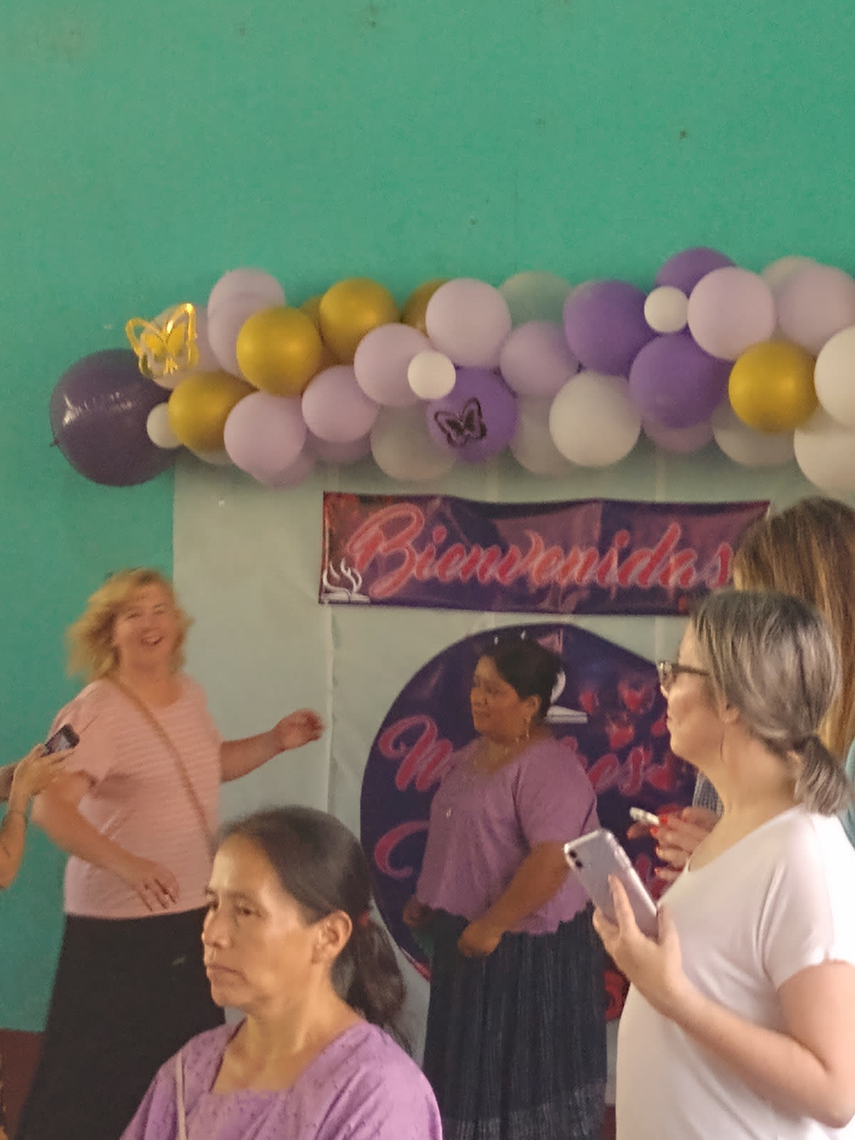 Women at a celebration decorated with balloons