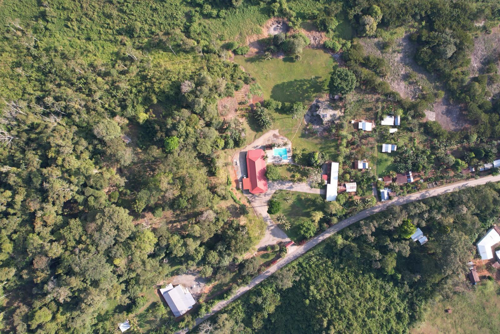 Aerial view of the El Puente Mission Station grounds among wooded hills