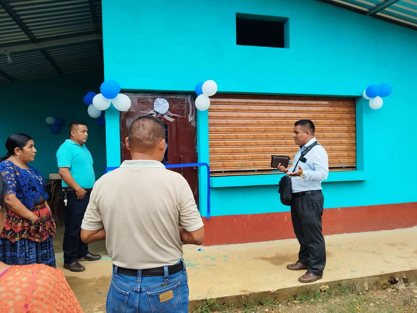 Ribbon-cutting outside a newly painted school building